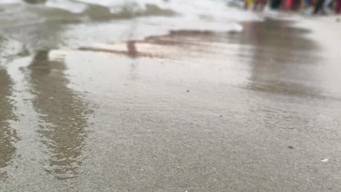 Close Up Gentle Ocean Waves Washing Over Wet Sandy Beach Shore Video stock 344583454