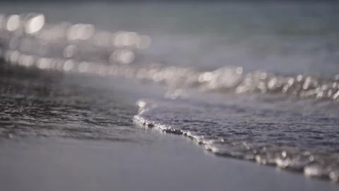 Close up of gentle wave break in slow motion on tropical island beach sun flare Stock Footage 288038578