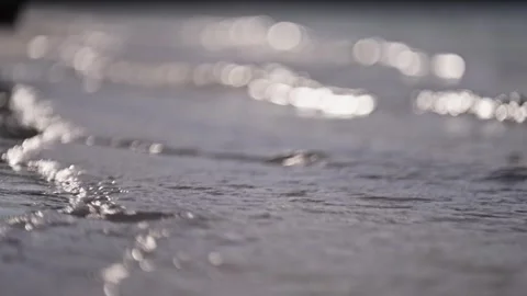 Close up of gentle wave break in slow motion on tropical island beach sun flare Stock Footage 288038580