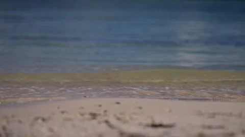 Close up of gentle wave break in slow motion on tropical island beach sun flare Stock Footage 288038581
