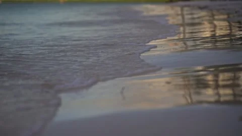 Close up of gentle wave break in slow motion on tropical island beach sun flare Stock Footage 288038584