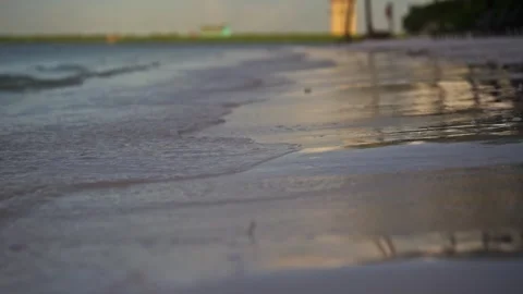 Close up of gentle wave break in slow motion on tropical island beach sun flare Stock Footage 288038585
