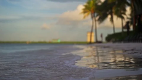 Close up of gentle wave break in slow motion on tropical island beach sun flare Stock Footage 288038587