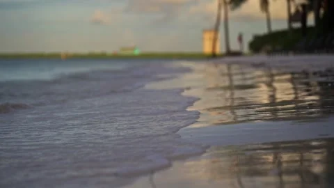 Close up of gentle wave break in slow motion on tropical island beach sun flare Stock Footage 288038591
