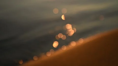 Close-up of gentle waves reflecting sunlight as they break on the beach Stock Footage 209163251