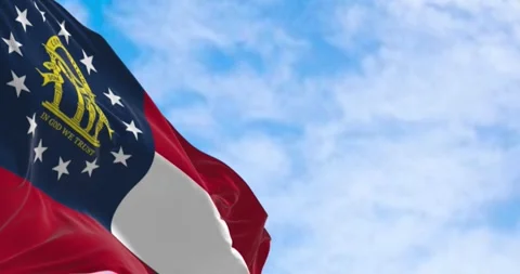 Close-up of Georgia state flag waving in the wind on a clear day Stock Footage 285513853