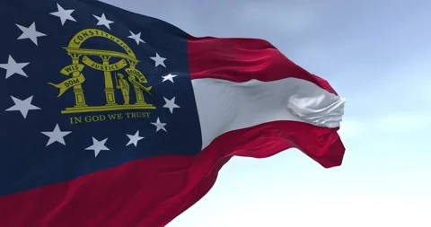 Close-up of Georgia state flag waving in the wind on a clear day Stock Footage 293779701