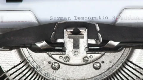 Close up GERMAN DEMOCRATIC REPUBLIC being typed on vintage typewriter Stock Footage 185148396