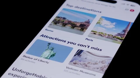 Close-up of the GetYourGuide app being opened from a smartphone home screen and Stock Footage 334059857