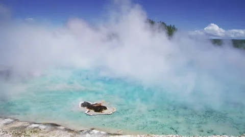 Close up of geyser crater with transparent waters and steam in Yellowstone park Stock Footage 271663752