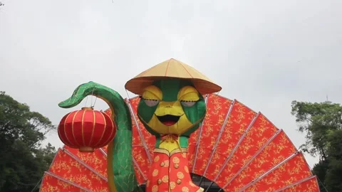 Close up giant lantern snake mascot in front of solo city hall yard Stock Footage 299961812