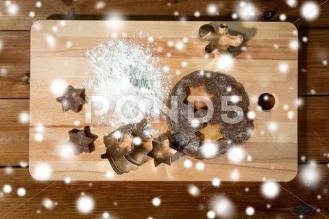 Close up of ginger dough, molds and flour on board Stock Photos