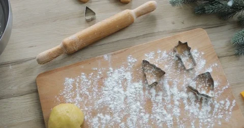 Close-up of gingerbread dough with flour and cookie cutter on table. making Stock Footage 81369307