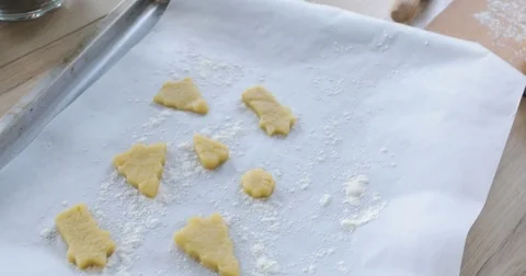Close-up of gingerbread dough with flour and cookie cutter on table. Traditional Stock Footage 81369947
