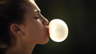 Close-Up Of Girl Blowing Chewing Gum Bubble In Ultra Slow Motion Stock Footage