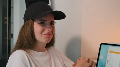 Close-up of a girl in a cap experiencing different emotions. Video stock 252455692