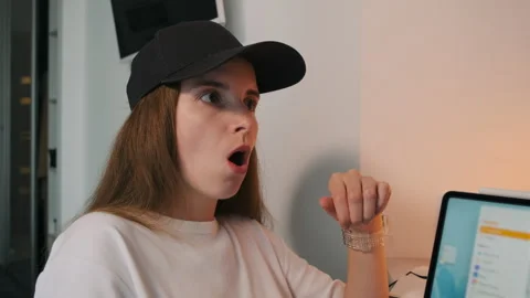 Close-up of a girl in a cap experiencing different emotions Stock Footage 252455695