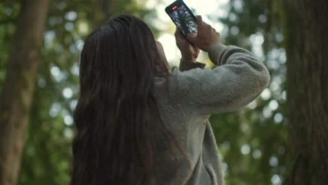 Close up of Girl content creator taking video for social media in forest 库存影片 221949393