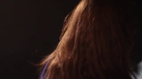 Close-up of a girl dancing in a dark studio with smoke. Stock Footage 72313801