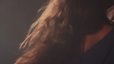 Close-up of a girl dancing in a dark studio with smoke. 動画素材 72313986