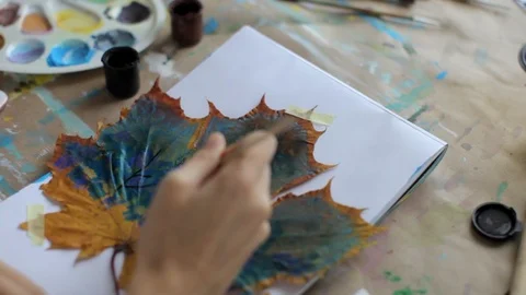 Close-up, girl drawing on a maple leaf Stock Footage 89540743