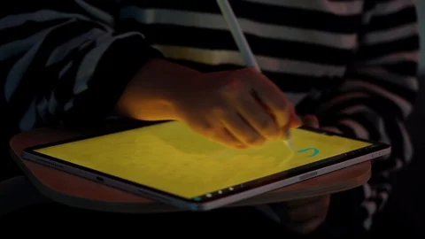 Close up of a girl drawing on a tablet with a digital pen the words "Stay Hom 스톡 동영상 129042959