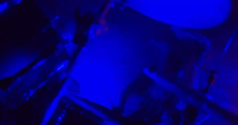 Close-up of girl emphatically playing the drums in twinkling strobe lights 스톡 동영상 170456232