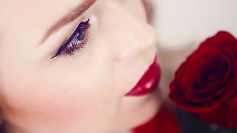 Close-up of girl face with red lips and red rose. Video stock 87870149