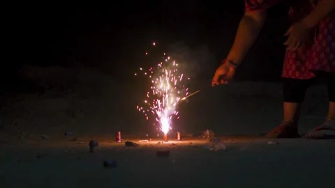 Close up of girl hand lighting up a firecrackers during Diwali festival in India Stock Footage 319004355
