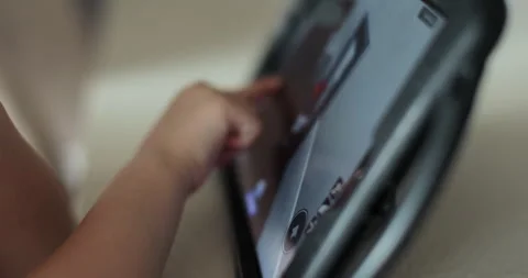 Close up of a girl hand is playing using digital computer tablet playing online Stock Footage 278534610