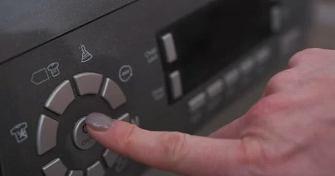 Close-up of girl hand presses button on control panel on washing machine Video stock 230093706