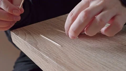 Close-up of the girl with her hands assembles a small building similar to a Stock Footage 204842747
