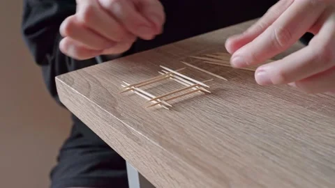 Close-up of the girl with her hands assembles a small building similar to a Stock Footage 207563813