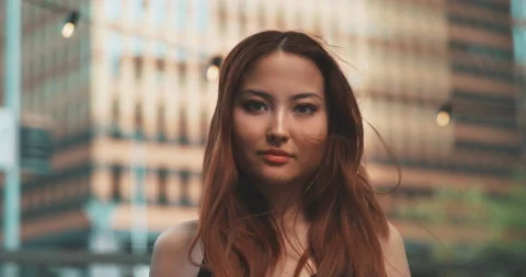 Close up of a girl looking at the camera in a windy day Stock Footage 201687192
