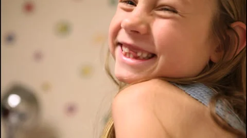 Close up of girl with missing teeth smiling and laughing Stock Footage 302244348