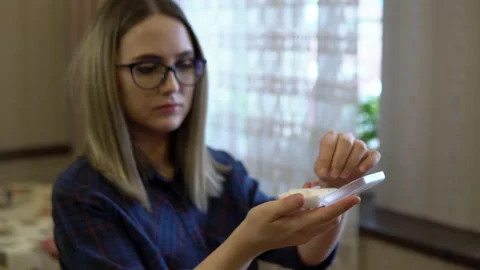 Close-up girl opens a box of pills and takes inside. Taking pills every day at Stock Footage 150034162