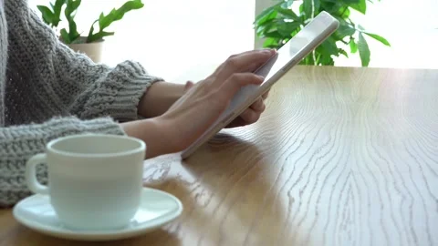 Close-up of girl in peach blouse using digital tablet Stock Footage 170776787