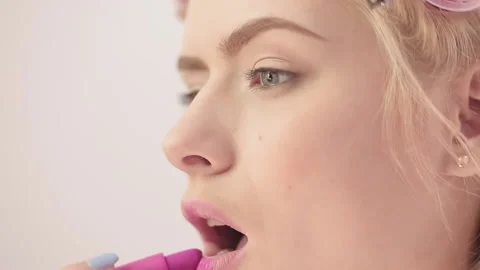 Close up of a girl puts lipstick while getting ready for a date. Girl who works Stock Footage 130603693