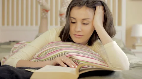 Close up of a girl reading in bed Stock Footage 62519192