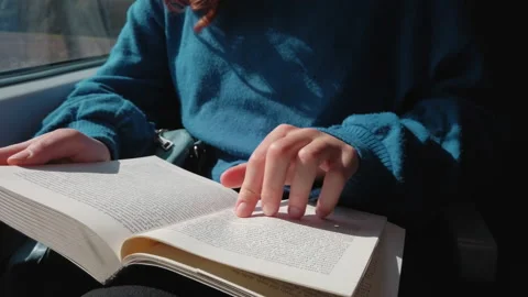 Close up of girl reading book on train Stock Footage 172069684