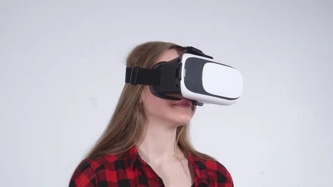 Close-up of the Girl that Rotates Head in Virtual Reality Helmet Stock Footage 82297680