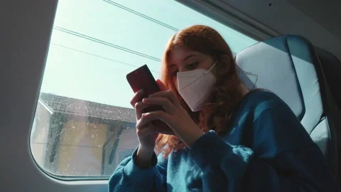 Close up of girl sitting on train using smartphone Stock Footage 172069717