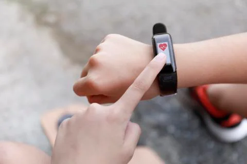 Close up Girl using smartwatch touching button and touchscreen on active spor Stock Photos