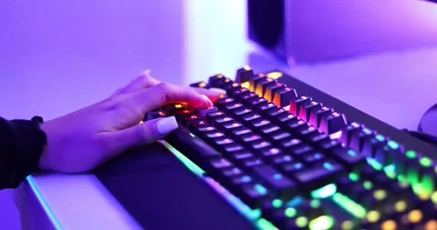 Close up of a girl using "W"."A","S","D" on a RGB keyboard to move the character Stock Footage 157408578