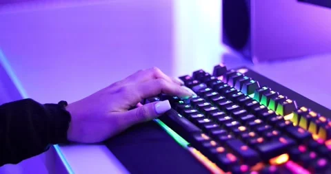 Close up of a girl using "W"."A","S","D" on a RGB keyboard to move the character Stock Footage 157408580