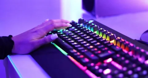 Close up of a girl using "W"."A","S","D" on a RGB keyboard to move the character Stock Footage 157408585