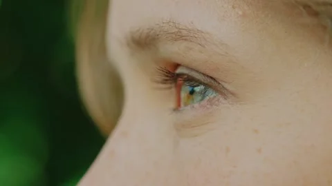 Close up girl's eye, she opens her eyes and looks to the side Stock Footage 201238550