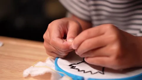 Close-up of a girl's hand embroidering a circle of embroidery with a frame. Stock Footage 313377853