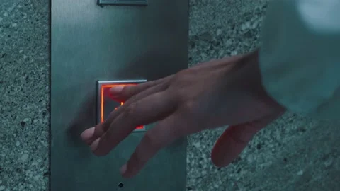 Close-up of a girl's hand pressing an elevator call button. Beautiful hands of a Stock Footage 146509762