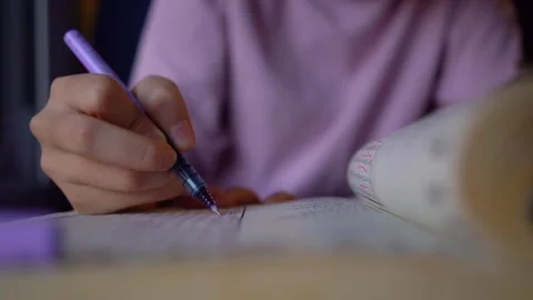 Close-up of a girl's hand while doing word searches with a pen on the train. Stock Footage 260191461